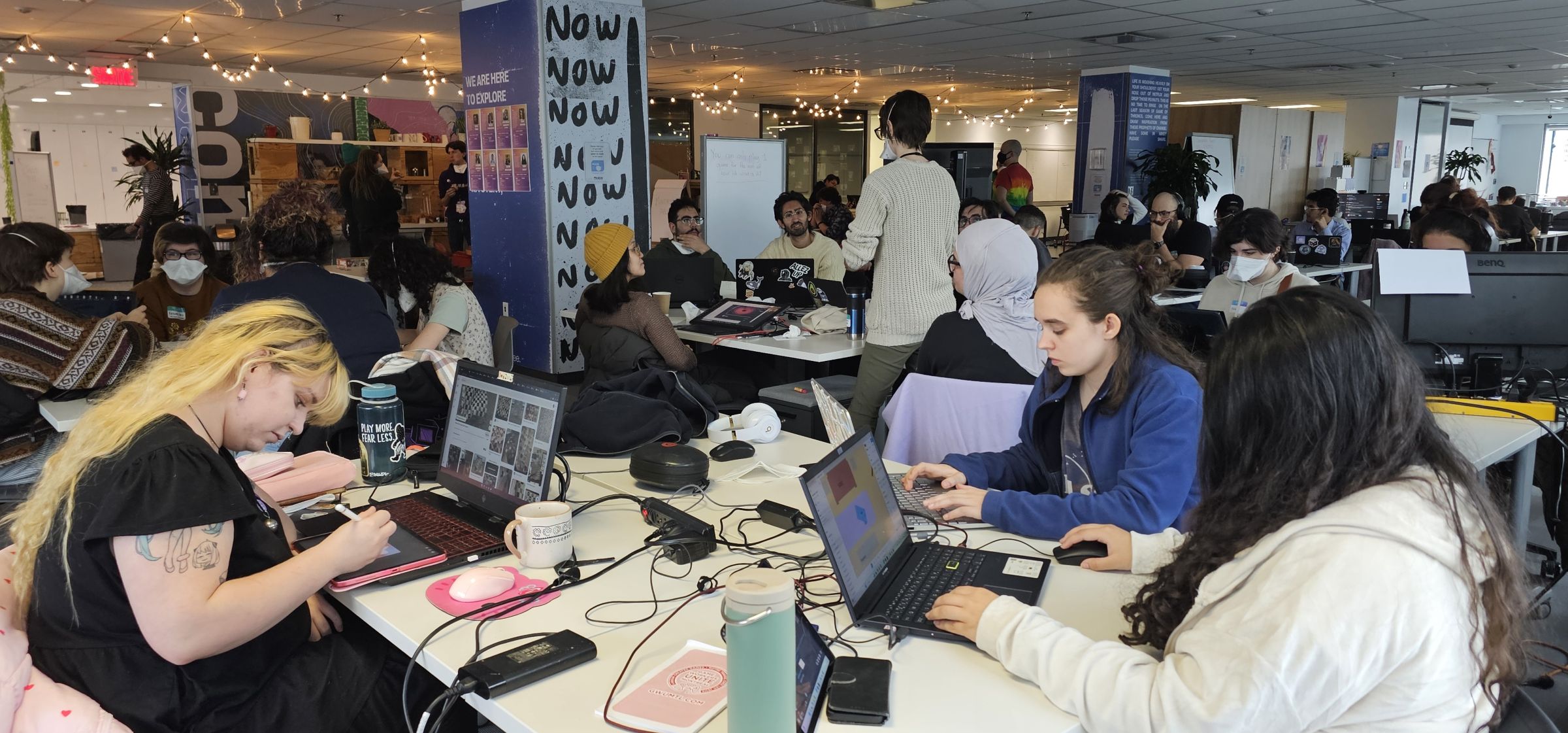 Jam participants playtest their game on their laptop